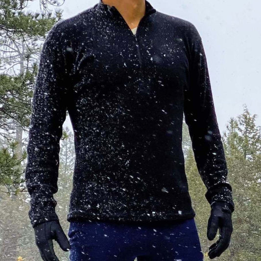 Man in snow wearing alpaca wool base layer and leggings