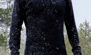 Man in snow wearing alpaca wool base layer and leggings