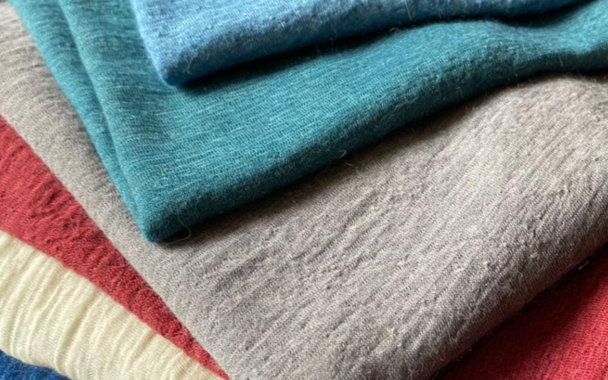 pile of naturally dyed alpaca wool clothing